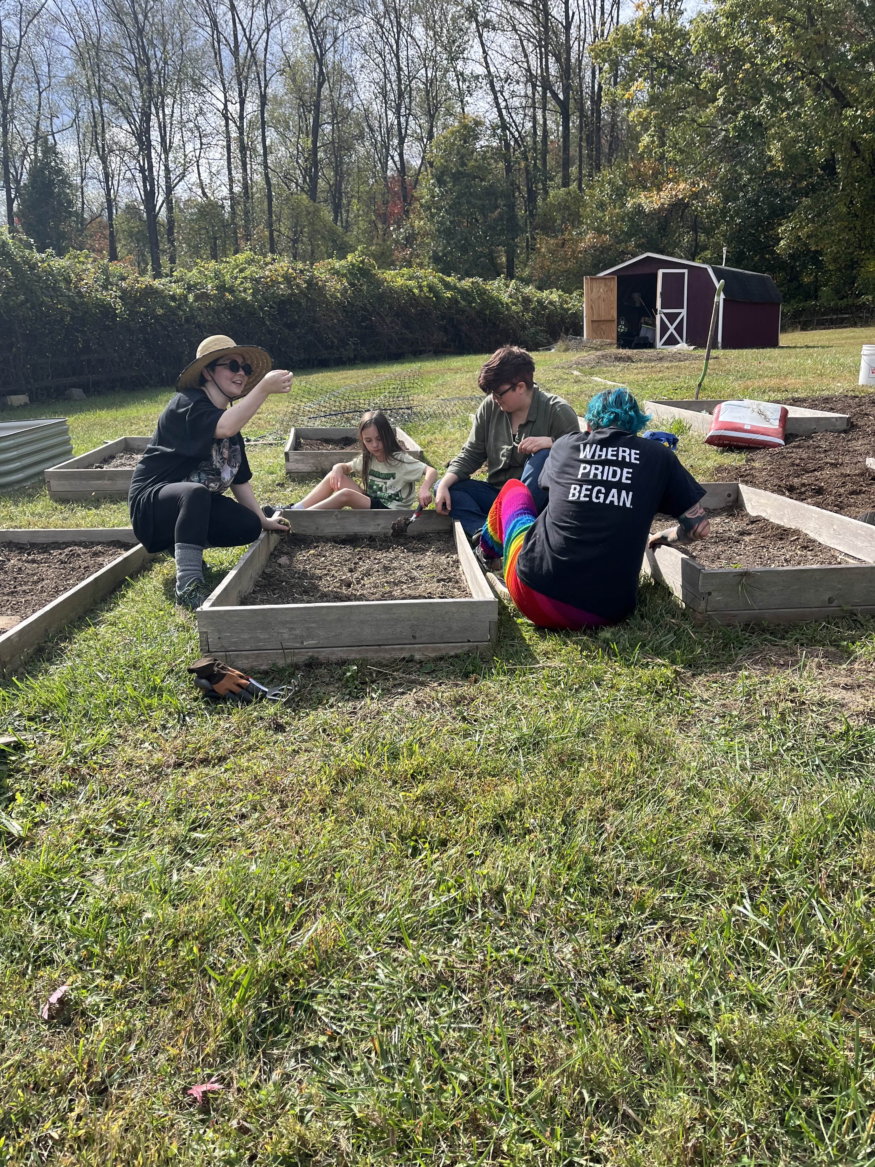 Chosen Love gardening collective members working together in raised garden beds